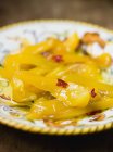 Marinated yellow peppers with chilli on plate — Stock Photo
