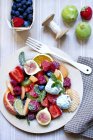 Large fruit salad with mint ice cream — Stock Photo