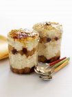 Closeup view of layered oatmeal with fruit and caramel in jars — Stock Photo
