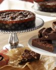 Assorted brownies serving on pedestal dishes — Stock Photo
