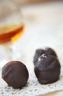 Closeup view of three chocolate truffles — Stock Photo
