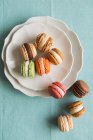Farbige Macarons auf gestapelten Tellern — Stockfoto