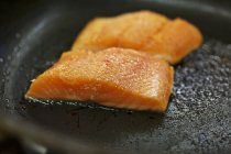 Salmon trout being fried — Stock Photo
