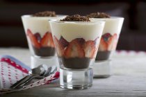 Closeup view of berry trifles with chocolate in glasses — Stock Photo