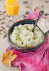 A Bowl of Mashed Turnips with Truffle Oil and Parsley and Spoon over pink towel — Stock Photo