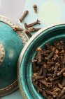 Cloves in green oriental bowl — Stock Photo