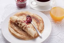 Pancakes with jam on plate — Stock Photo