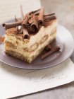 Tiramisu cake topped with rolls of chocolate — Stock Photo