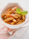 Penne arrabiata pasta with basil — Stock Photo