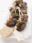 Date skewers with dry-cured ham — Stock Photo