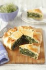 Closeup view of spinach pie with almonds — Stock Photo