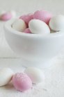 Closeup view of sugar eggs and white bowl — Stock Photo