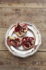 Closeup view of pomegranate pieces on metal plate — Stock Photo