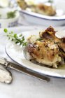 Closeup view of chicken with herbs on plate — Stock Photo