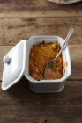 Vista sopraelevata dello stufato di pollo con cucchiaio in piatto di ceramica — Foto stock