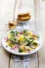 Ceviche with asparagus and grapefruit on white plate  over wooden surface — Stock Photo