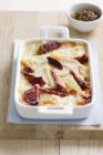 Potato and beetroot gratin in a casserole dish over towel — Stock Photo