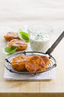 Closeup view of sweet potato fritters with herbal dip — Stock Photo