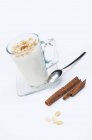 Closeup view of Sahlab with hot milk, peanuts and cinnamon sticks — Stock Photo