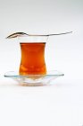 Asian tea in glass with spoon — Stock Photo