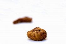 Closeup view of dried figs on white surface — Stock Photo