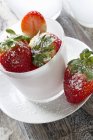 Strawberries with icing sugar — Stock Photo