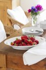 Fresh strawberries in white plate — Stock Photo