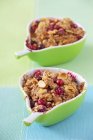 Closeup view of cranberry crumbles with almonds in pear-shaped dishes — Stock Photo