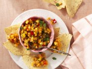 Top view of peach Salsa with tortilla chips — Stock Photo