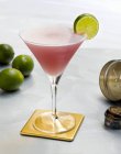 Cosmopolitan on a Coaster with a Lime Slice — Stock Photo