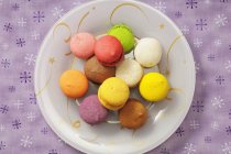 Colourful macaroons on plate — Stock Photo