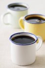 Black coffee in enamel mugs — Stock Photo