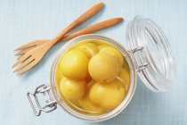 Preserving jar with lemons in brine — Stock Photo