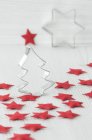Christmas decorations, with cookie cutters and red felt stars — Stock Photo