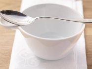 Closeup view of an empty soup bowl and spoon — Stock Photo
