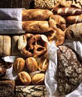 Assorted breads on baking parchment — Stock Photo