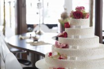 Wedding cake decorated with white ribbons — Stock Photo