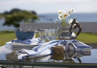 Vista diurna di piatti e bicchieri su un tavolo esterno — Foto stock
