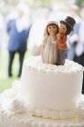 Cake with decorative bride and groom — Stock Photo