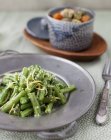 Closeup view of green bean salad with bowl of curried turkey stew — Stock Photo