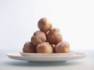 Stack of profiteroles on plate — Stock Photo
