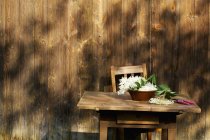 Daytime view of fresh Elderflowers in bowl on rustic wooden table — Stock Photo