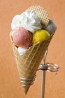 Fruit ice cream with cream in a wafer cone — Stock Photo