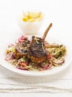Lamb chops on a bed of couscous — Stock Photo