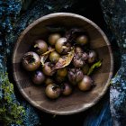 Fresh Medlars in wooden bowl — Stock Photo