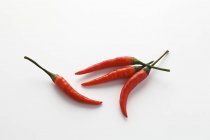 Four red chillies — Stock Photo