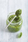 Pesto in jar and on spoon — Stock Photo