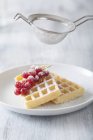 Waffles with redcurrants on plate — Stock Photo
