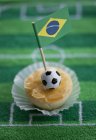 Closeup view of Empadinhas small pie with a Brazilian flag — Stock Photo