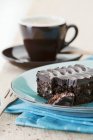 Fresh baked brownie serving on blue plate — Stock Photo